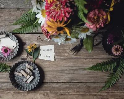 Dried flowers and a handwritten tag on a rustic wooden table