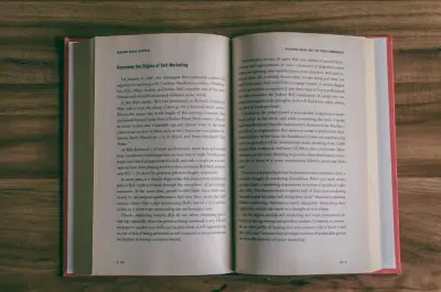 An old book lying open on a wooden table